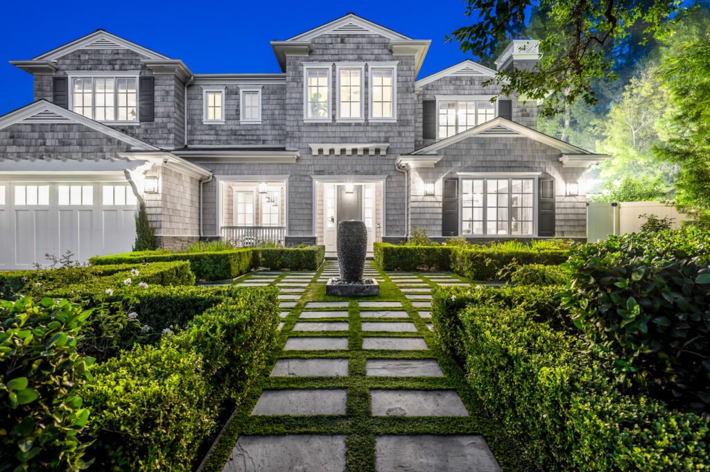 A breathtaking Arizona luxury home with elegant architecture, lush landscaping, and a beautifully lit exterior, exuding sophistication and charm.